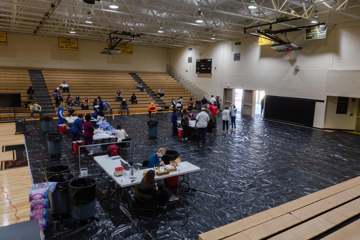 Healthcare workers administer doses of the Pfizer-BioNTech Covid-19 vaccine to staff members of the Clarendon School District at Manning High School in Manning, South Carolina, U.S., on Friday, March 12, 2021. (Micah Green/Bloomberg via Getty Images)