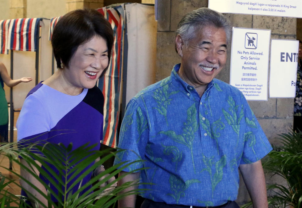 In this Wednesday, Aug. 8, 2018 photo, Hawaii Gov. David Ige, right, and first lady Dawn Amano Ige smile after voting early in the state's primary election in Honolulu. Ige is seeking the nomination for a second term in office in Saturday's Democratic primary. He is being challenged by U.S. Rep. Colleen Hanabusa, who is giving up her seat in Congress to challenge the governor. (AP Photo/Caleb Jones)