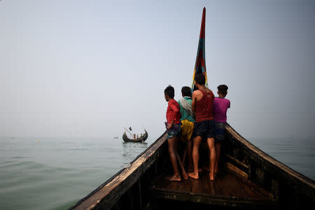 Rohingya refugees crew a fishing boat in the Bay of Bengal near Cox's Bazaar, Bangladesh, March 24, 2018. REUTERS/Clodagh Kilcoyne