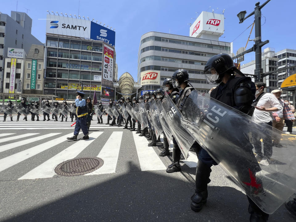 Police prepare to confront protesters marching against the Group of Seven (G7) meeting being held in Hiroshima, western Japan, Sunday, May 21, 2023. (AP Photo/Adam Schreck)