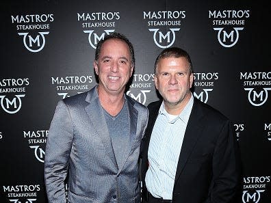 Rich Handler and Tilman Fertitta posing for a photo.