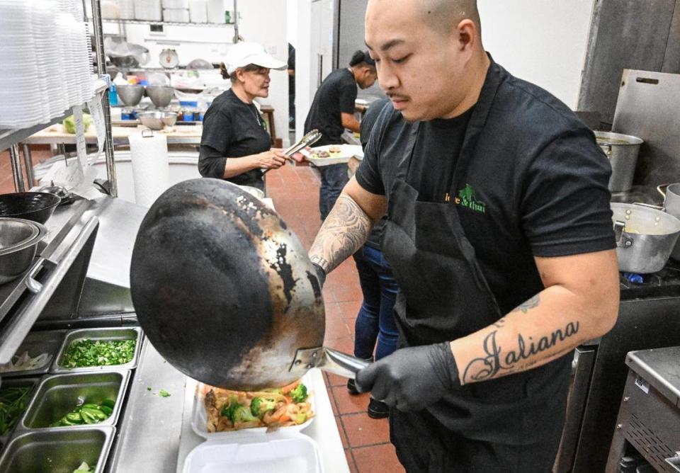 Jay Sitthi prepares a pad se-ew combo plate while working in the kitchen at Love & Thai during their soft opening on Wednesday, Oct. 3, 2023.