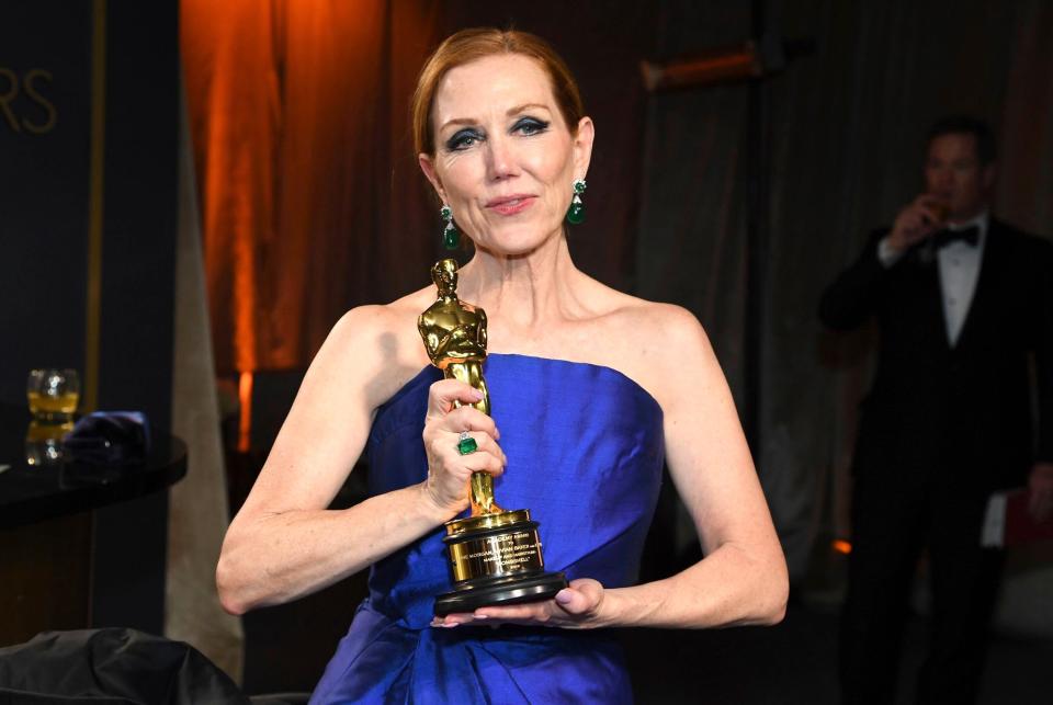 Anne Morgan, who won the Oscar for Best Makeup and Hairstyling for <em>Bombshell</em>, poses with her trophy the the Governors Ball after the Oscars. 