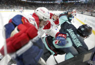 Montreal Canadiens defenseman Alexander Romanov (27) knocks down Seattle Kraken center Calle Jarnkrok (19) during the third period of an NHL hockey game, Tuesday, Oct. 26, 2021, in Seattle. The Kraken won 5-1. (AP Photo/Ted S. Warren)
