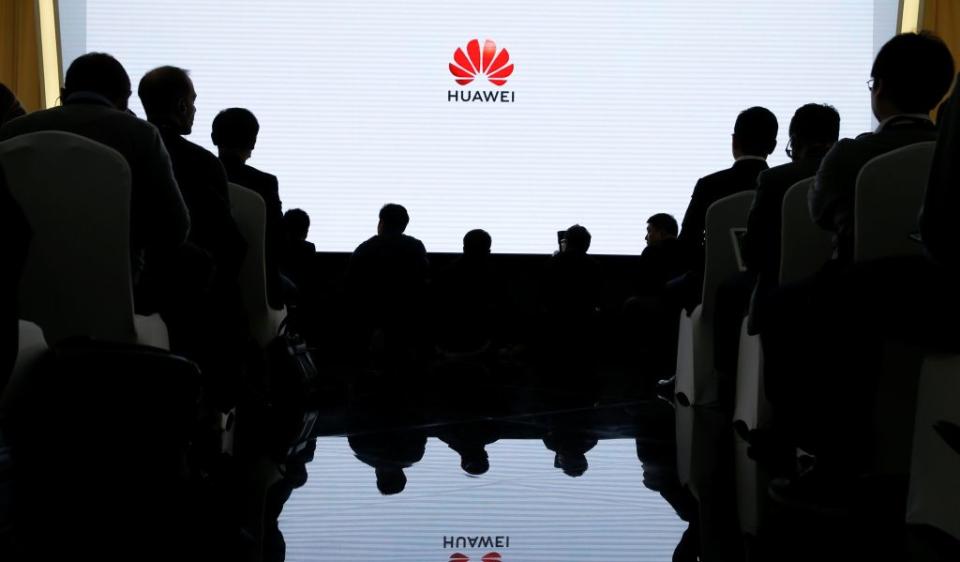 People attend a product presentation at Huawei in Beijing, China, January 24, 2019. REUTERS/Thomas Peter - RC121EC8E140