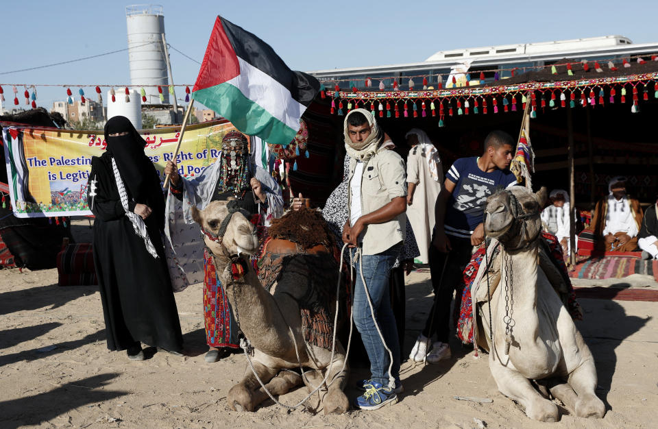 In this Sept. 25, 2019 photo, Palestinians attend an alternative protest organized by activist Ahmed Abu Artima near the separation fence between the Gaza Strip and Israel, east of Gaza City. Gaza’s Hamas rulers are facing a rare and growing chorus of criticism, with little to show after 18 months of mass protests along the Israeli border organized by the Palestinian militant group. Gazans are increasingly questioning the high number of casualties and lack of success in lifting the Israeli blockade. Against this backdrop, Artima has launched his own peaceful version of the protest. (AP Photo/Adel Hana)