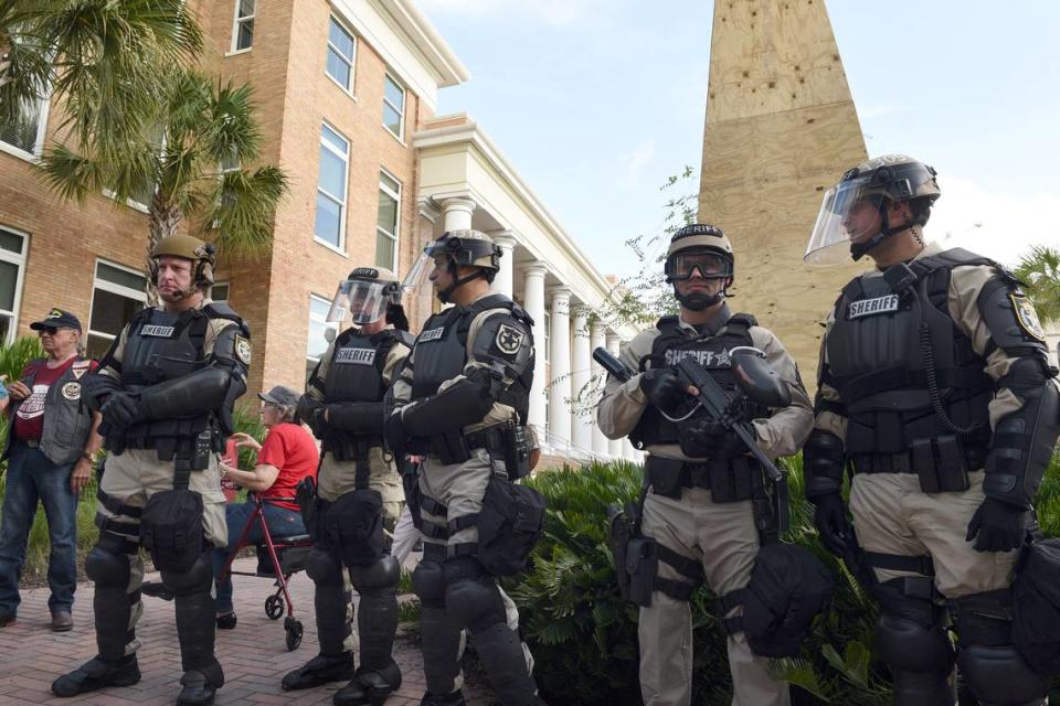 Manatee County Sheriff’s deputies patrol on horseback, on roofs and surrounding the monument as protesters demanding the Confederate monument’s removal and counter protestors wanting it to remain gather at the historic courthouse Monday.