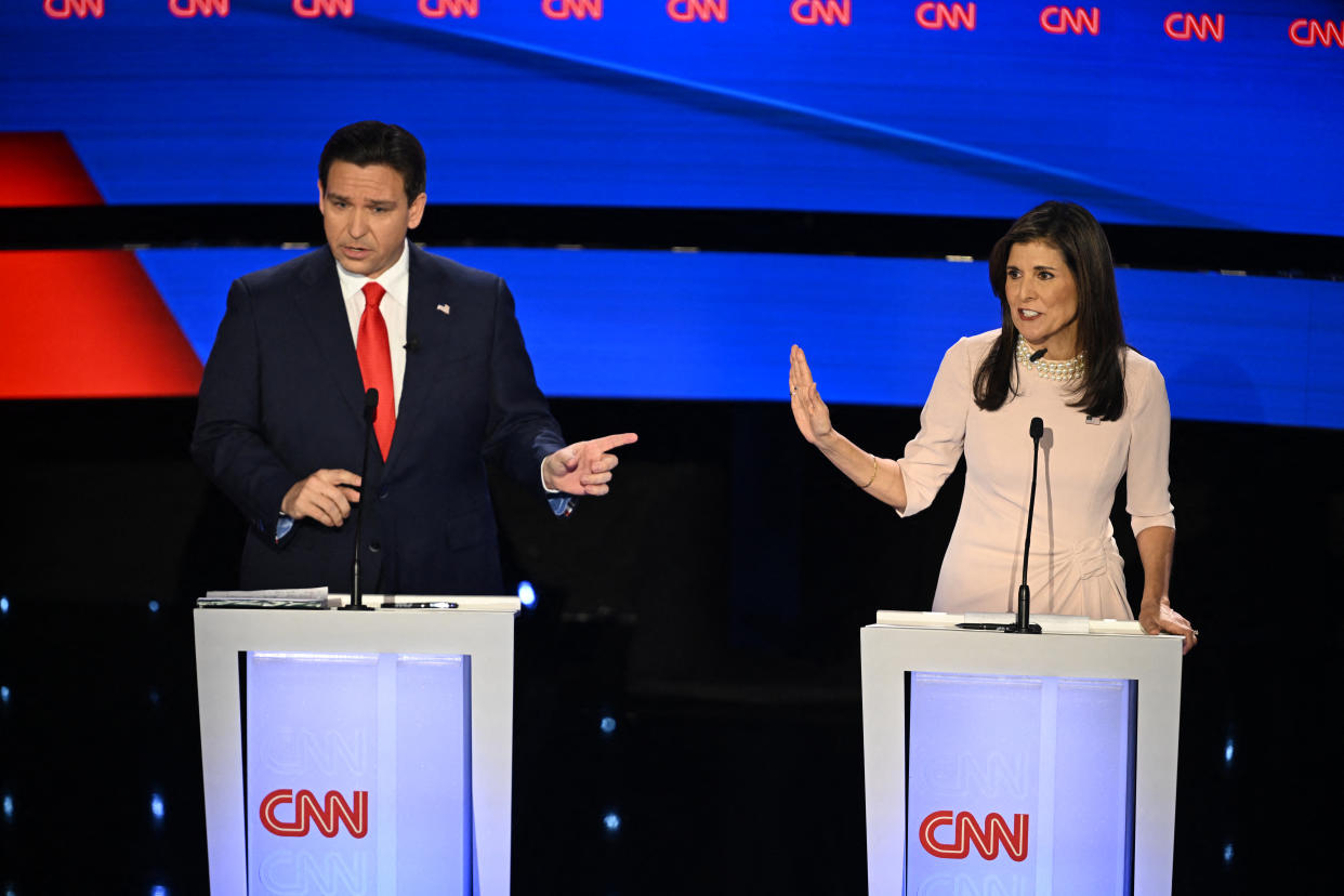 Ron DeSantis and Nikki Haley stand onstage at podiums emblazoned with CNN logo.