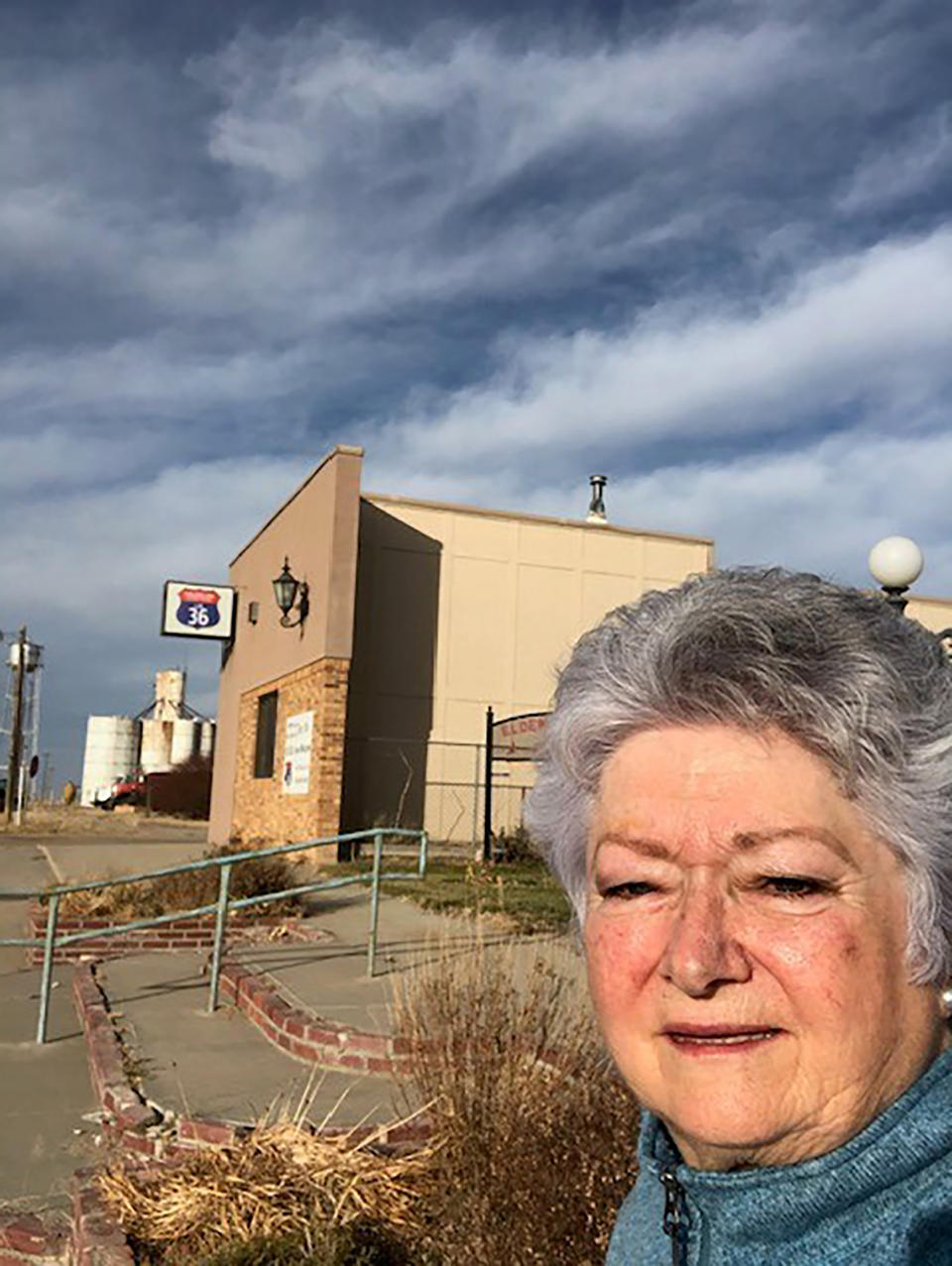 In this photo provided by Carolyn Plotts, Plotts is seen in Norcatur, Kan., on Nov. 18, 2020. Not much left in Norcatur except for a service station, a grain elevator, a little museum, and a weekend hangout where the locals play pool, eat pizza and drink beer. But for the 150 or so people who still call this rural hamlet home the cancellation this year of the town's beloved Norcatur Christmas Drawing has shone a spotlight on a global coronavirus pandemic that has reached deep into rural America. (Carolyn Plotts via AP)