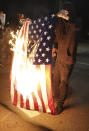 A protester burns an American flag while rallying at the Mark O. Hatfield United States Courthouse on Saturday, Sept. 26, 2020, in Portland, Ore. The rally came as Portland has seen nearly nightly protests since the police killing of George Floyd in late May. (AP Photo/Allison Dinner)