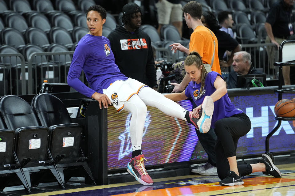 Phoenix Mercury center Brittney Griner stretches prior to a WNBA preseason basketball game against the Los Angeles Sparks, Friday, May 12, 2023, in Phoenix. (AP Photo/Matt York)