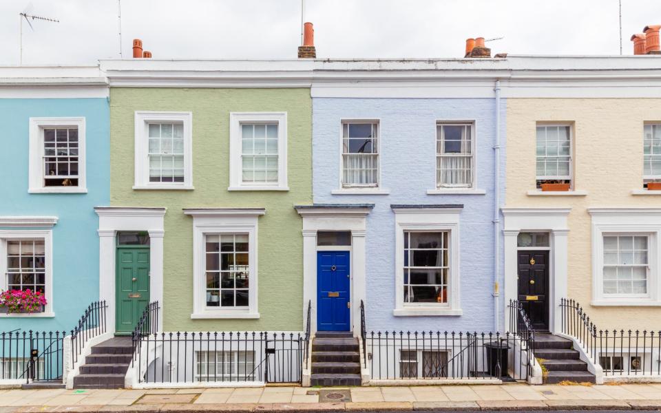 Multi-colored townhouses in Notting Hill, London, UK - Getty