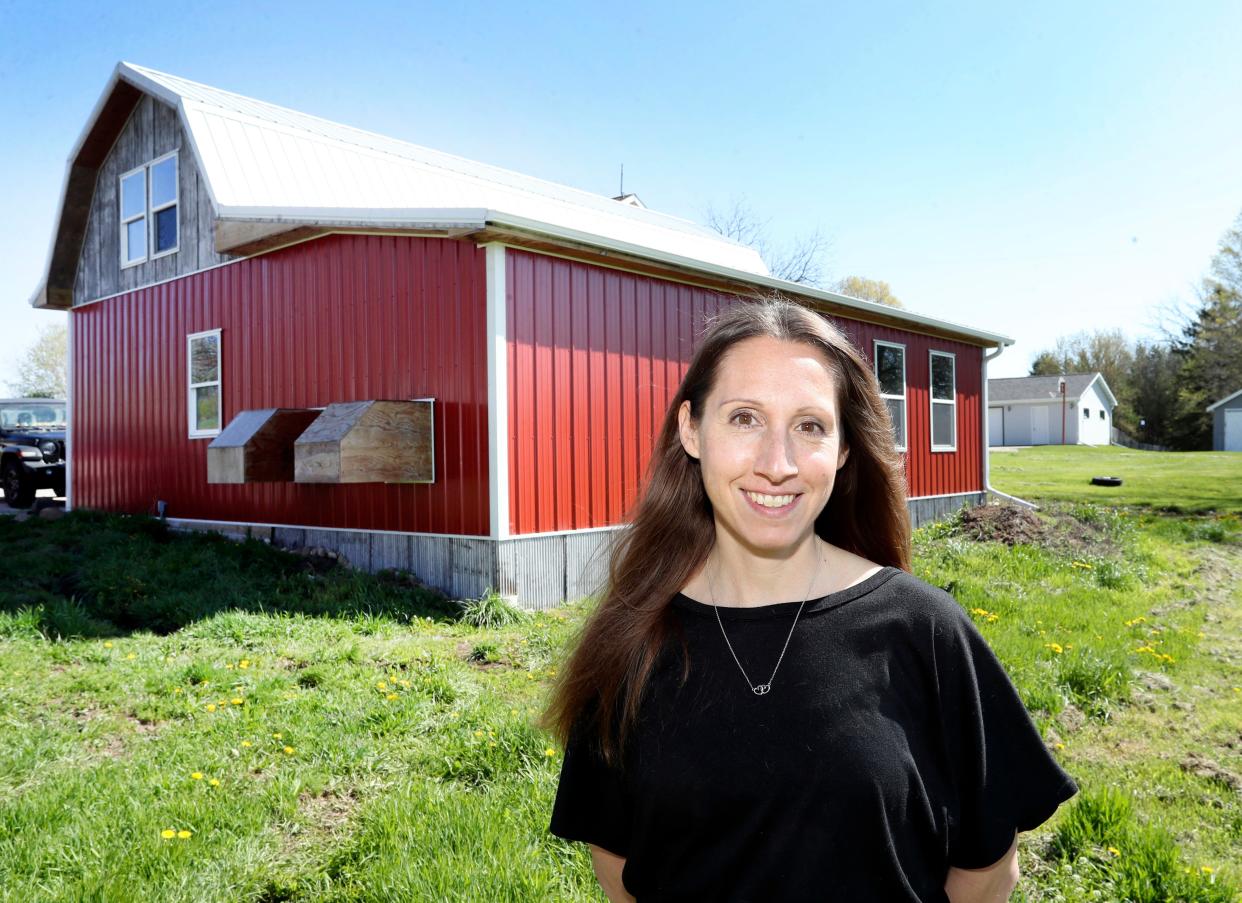 Director of Behavioral Health Katie Heinzen poses by a new barn at The Production Farm, Friday, May 3, 2024, in Whitelaw, Wis.