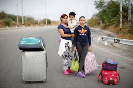 The Wider Image: Venezuelan mothers, children in tow, rush to migrate