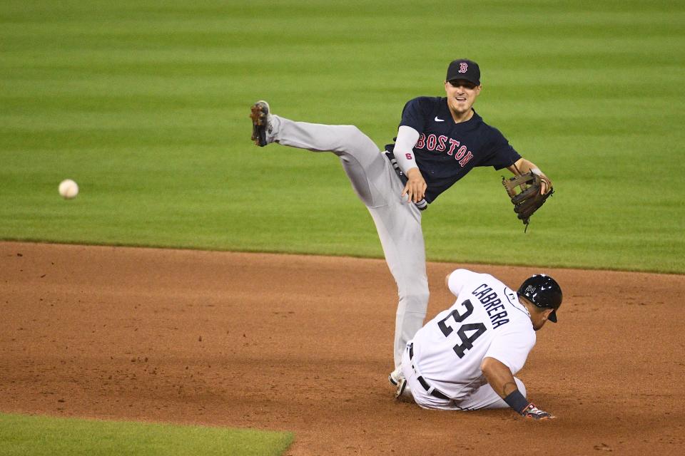 Boston Red Sox second baseman Enrique Hernandez (5) forces out Detroit Tigers first baseman Miguel Cabrera (24) at second base and throws to first base during the sixth inning at Comerica Park on August 4, 2021.