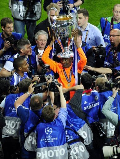 Chelsea's forward Didier Drogba (C) celebrates with the trophy after the UEFA Champions League final. Drogba was the hero as Chelsea shattered Bayern Munich's Champions League dream with victory in a nail-biting penalty shoot-out