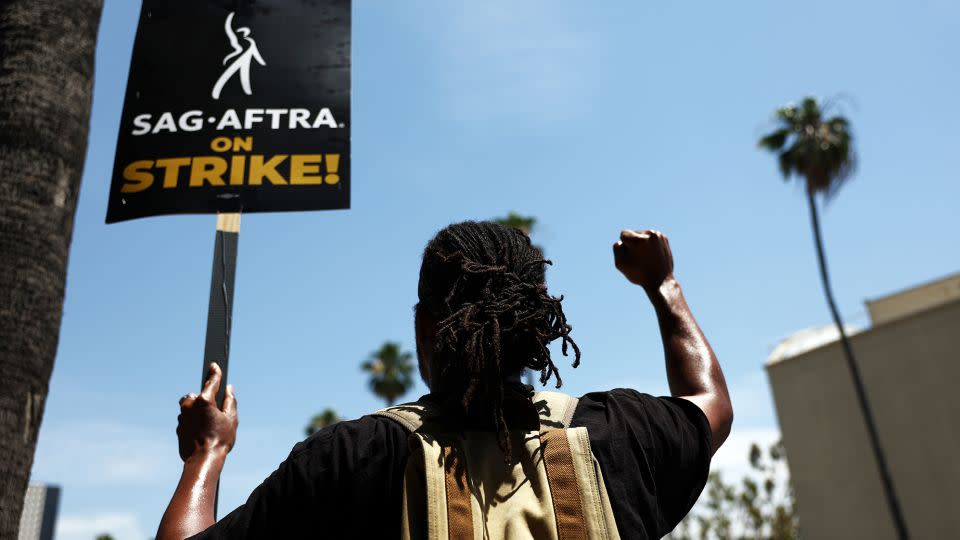 Striking SAG-AFTRA member James Mathis III on the pickett line. - Mario Tama/Getty Images