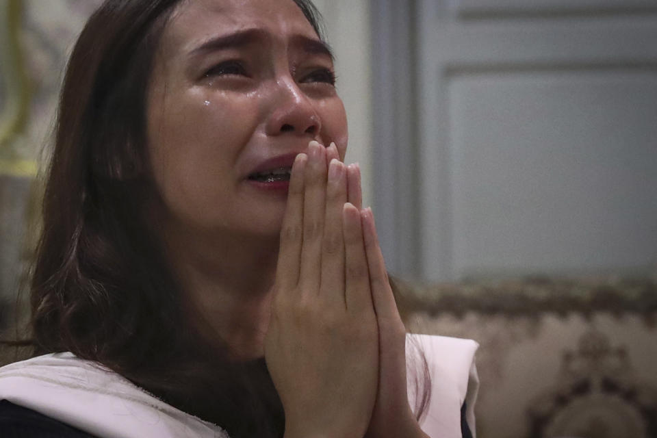 Tri Novia Septiani cries during an online memorial service marking the 40th day since the death of her fiance Dr. Michael Robert Marampe who died of COVID-19, in Jakarta, Indonesia, on June 5, 2020. Marampe knew what he wanted to be since he was a kid: a doctor and a pianist. He became both, and his passion for music even led him to Septiani - a woman he never got to marry because he got the coronavirus. (AP Photo/Tatan Syuflana)