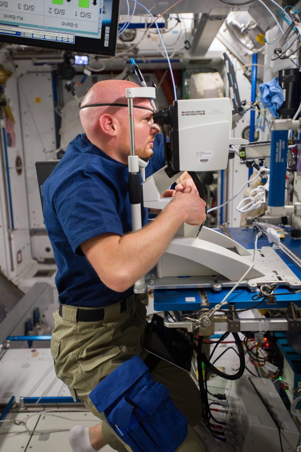 Astronaut Alexander Gerst takes a vision test on board a space craft.