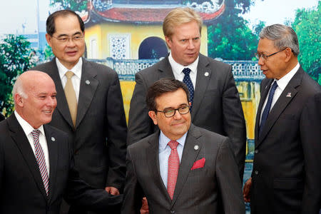 Trade ministers pose for a group photo during the APEC Ministers Responsible For Trade (APEC MRT 23) meeting in Hanoi, Vietnam May 20, 2017. From L-R, front: Peru's Foreign Commerce and Tourism Minister Eduardo Ferreyros, Mexico's Economic Secretary Ildefonso Guajardo. From L-R, back: Singapore's Trade Minister Lim Hng Kiang, New Zealand's Trade Minister Todd McClay and Malaysia's Trade Minister Mustapa Mohamed. REUTERS/Kham