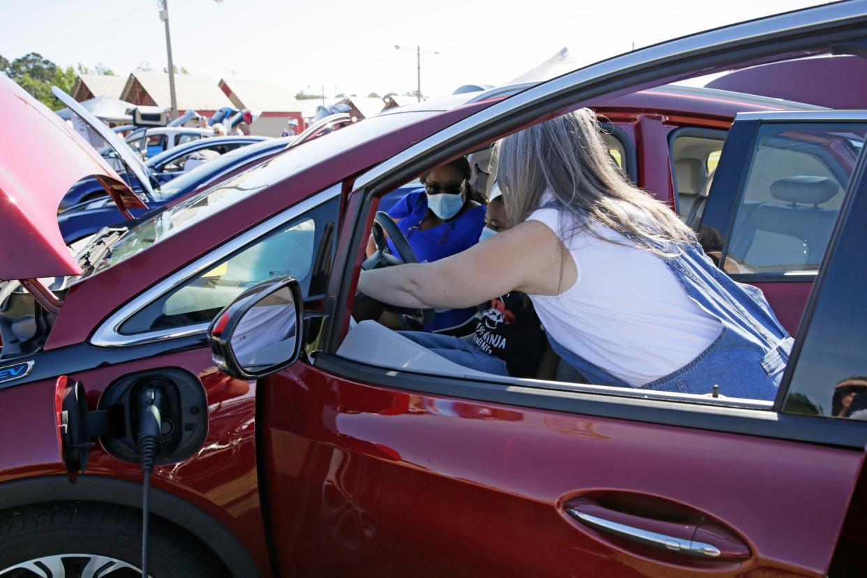 One of the more popular attractions at Springtime Tallahassee  in 2021 was the electric car exhibit. Here Donna Johnson and her son Antonio Perry sit behind the wheel and investigate. "I figured now is a good time to at least look," said Donna. "I paid $3.69 a gallon this morning for gas because the station only had premium."