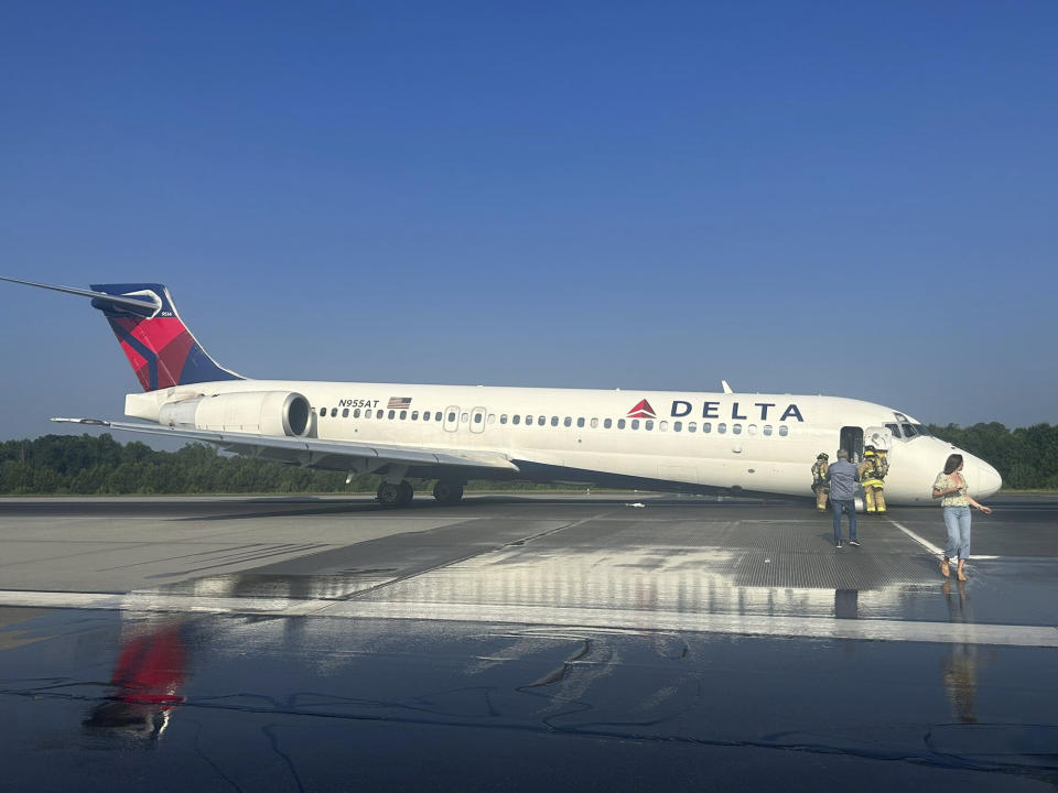 Airport and emergency personnel are on the scene as a Delta plane lands without its landing gear at the Charlotte Douglas International Airport, Wednesday, June 28, 2023 in Charlotte, N.C. The airport said in a tweet that the runway was closed following a mechanical issue with Delta Air Lines. No injuries were reported and all passengers were taken to the terminal. The airport said it was working to remove the aircraft and reopen the runway. (Chris Skotarczak via AP)