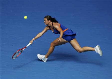 Vesna Dolonc of Serbia hits a return to Serena Williams of the U.S. during their women's singles match at the Australian Open 2014 tennis tournament in Melbourne January 15, 2014. REUTERS/Jason Reed