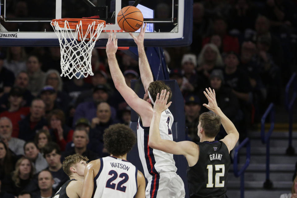Gonzaga forward Drew Timme (2), second from right, shoots in front of Washington forward Jackson Grant (12) during the first half of an NCAA college basketball game, Friday, Dec. 9, 2022, in Spokane, Wash. (AP Photo/Young Kwak)