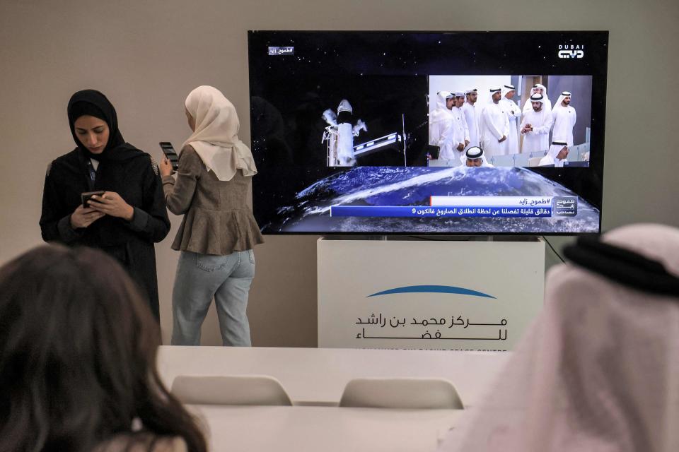 Emirati observers watch at the Mohammed bin Rashid Space Centre in Dubai on February 27, 2023 as a screen shows the SpaceX Falcon 9 rocket with the company's Crew Dragon spacecraft venting fuel prior to a scrubbed launch from pad 39A for the Crew-6 mission at NASA's Kennedy Space Center in Cape Canaveral, Florida. The SpaceX Falcon 9 rocket launch to the International Space Station was postponed on February 27, with officials citing problems with ground systems.