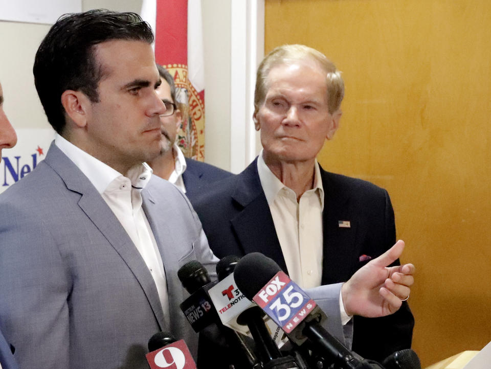 Puerto Rico Governor Ricardo Rossello, left, endorses U.S. Sen. Bill Nelson for the senate during a news conference Monday Oct. 1, 2018, in Orlando, Fla. (AP Photo/John Raoux)