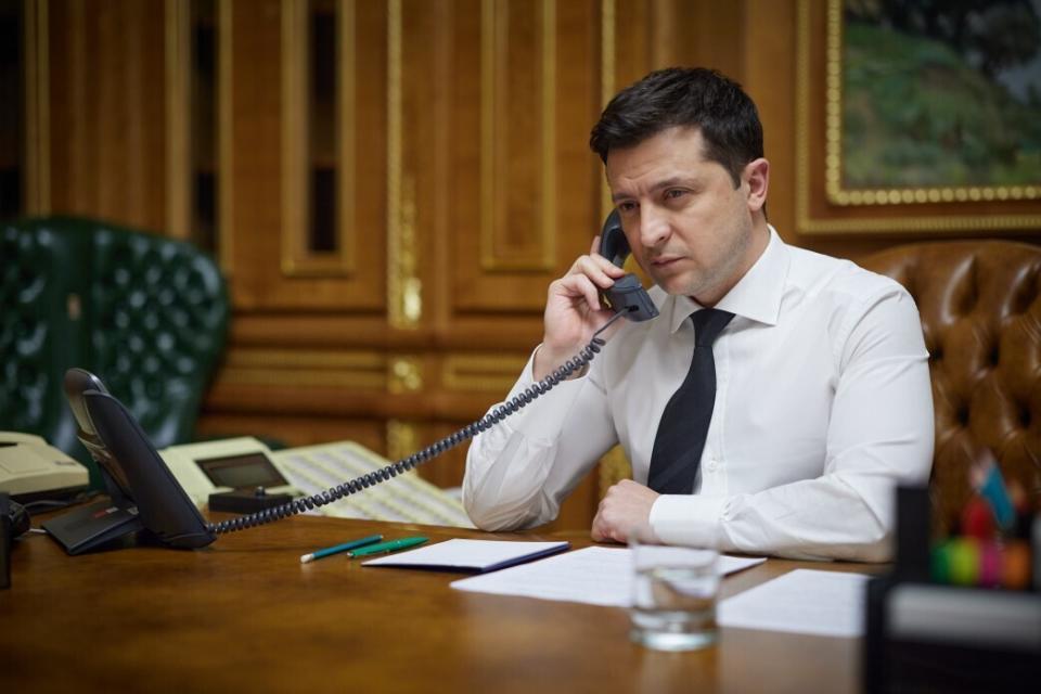 Ukrainian President Volodymyr Zelenskyy speaks with U.S. President Joe Biden over the telephone in his office in Kyiv, Ukraine, Thursday, Dec. 9, 2021. (Ukrainian Presidential Press Office via AP)