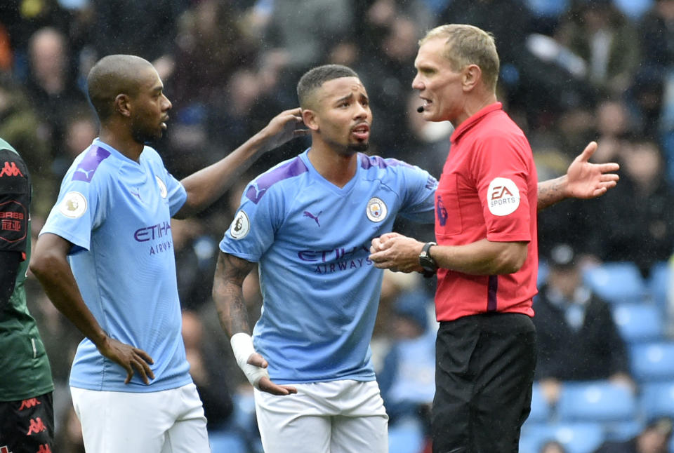 Manchester City's Gabriel Jesus, left, and Manchester City's Fernandinho argue with referee Graham Scott during the English Premier League soccer match between Manchester City and Aston Villa at Etihad stadium in Manchester, England, Saturday, Oct. 26, 2019. (AP Photo/Rui Vieira)