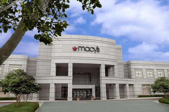 A Macy's store as seen from outside, with a tree in the foreground.