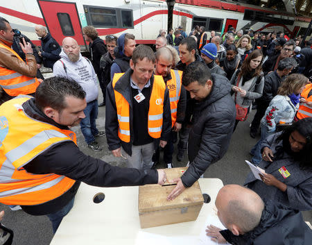 Railway workers cast their ballots as they vote about the strike at the Nice railway station on the second day of a nationwide strike by French SNCF railway workers in Nice, France, April 4, 2018. REUTERS/Eric Gaillard