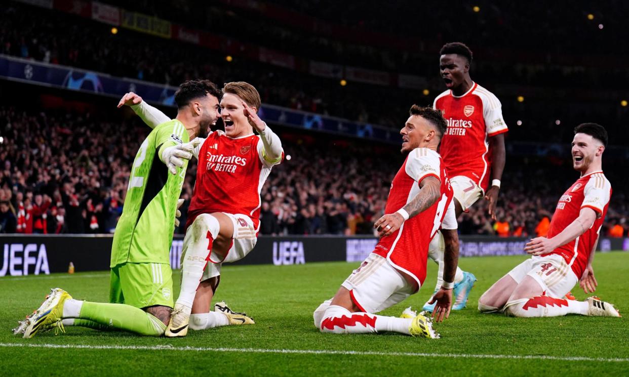 <span>Arsenal players race towards their goalkeeper David Raya after his second shootout save sealed their Champions League progress.</span><span>Photograph: Zac Goodwin/PA</span>