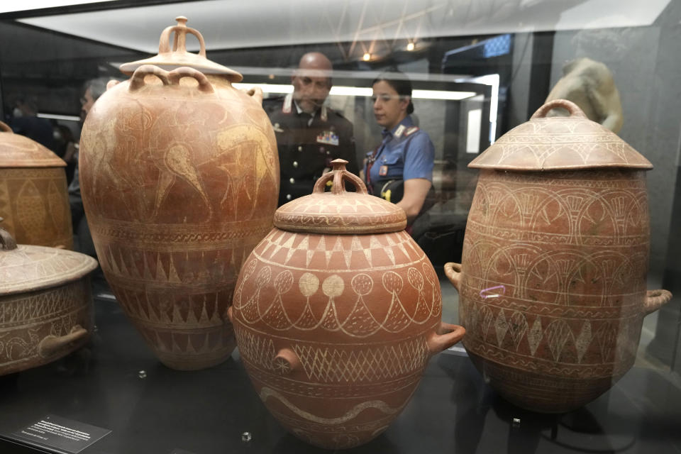 Etruscan jars from the 7th century B.C. are displayed in the new "Museum of Rescued Art" in Rome, Wednesday, June 15, 2022. Italy has been so successful in regaining ancient artworks and artifacts illegally exported from the country that it has now created a museum just for them, the Museum of Rescued Art, inaugurated on Wednesday in the cavernous Octagonal Hall of the ancient Baths of Diocletian. (AP Photo/Alessandra Tarantino)