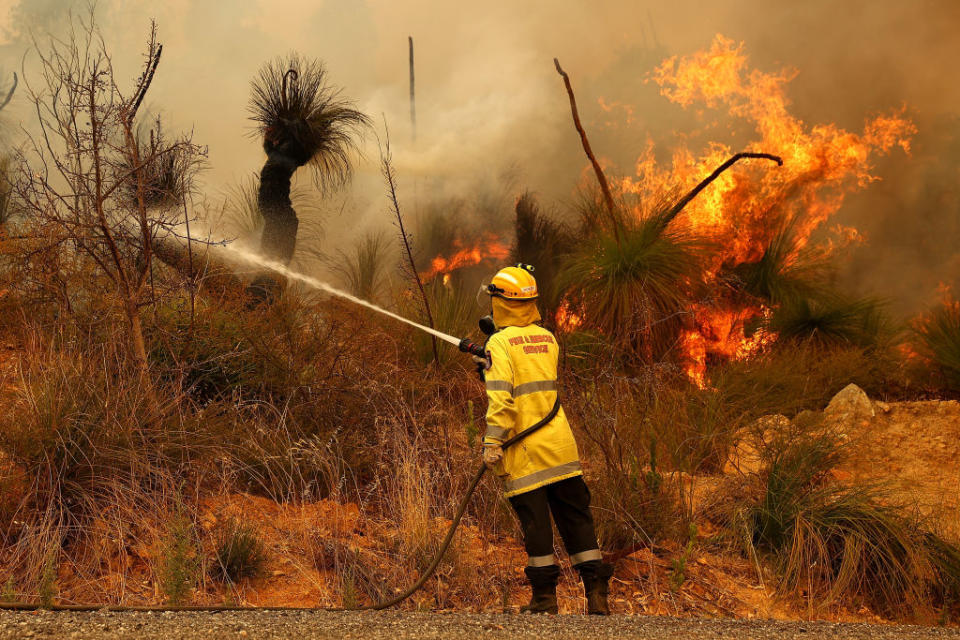 Fire crews control bush fires as they approach properties on Copley Road in Upper Swan in Perth, Australia. 
