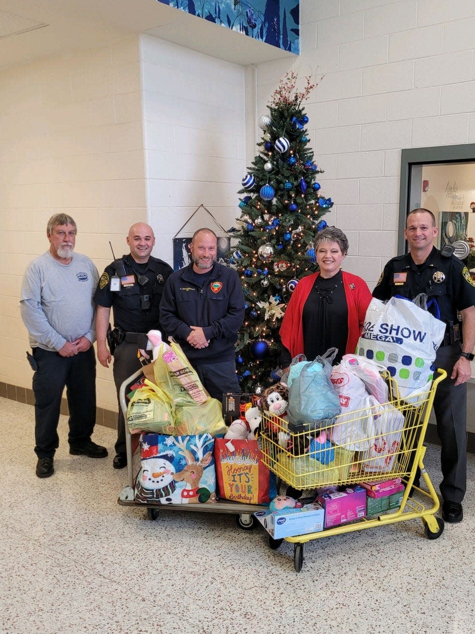 (From left) Casar Mayor Eddie Walker, Casar SRO Johnathan Smith, Casar fireman Dave Descourouez, Casar Elementary receptionist Amy Carpenter and Lieutenant Daniel Howell pose for a photo along with items collected for children in need in Kentucky.