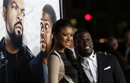 Cast member Kevin Hart and Eniko Parrish pose at the premiere of "Ride Along" at the TCL Chinese theatre in Hollywood, California January 13, 2014. REUTERS/Mario Anzuoni