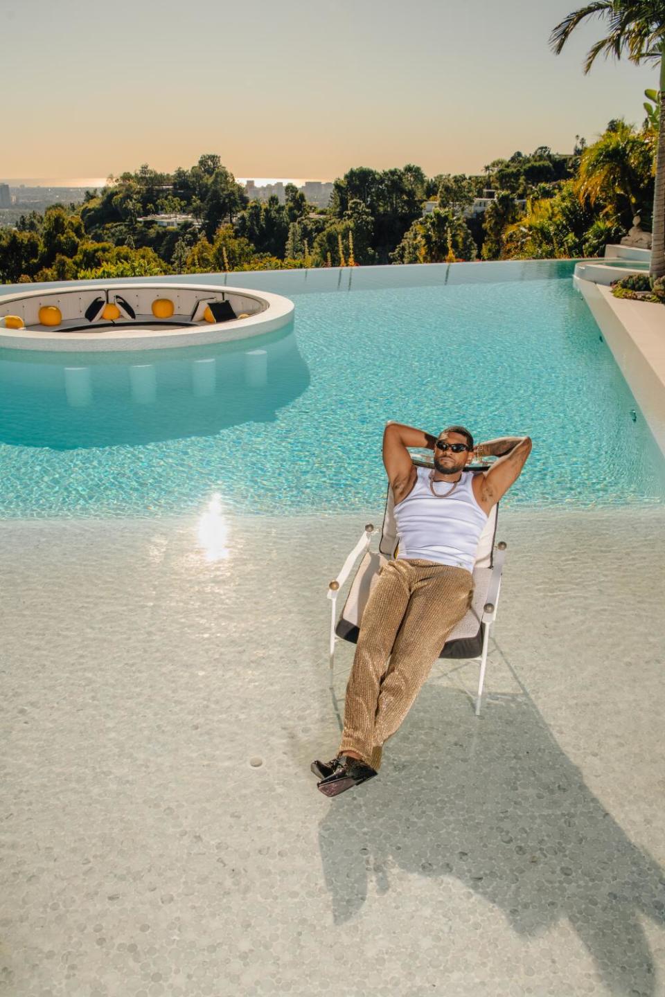 A man sits pool side.