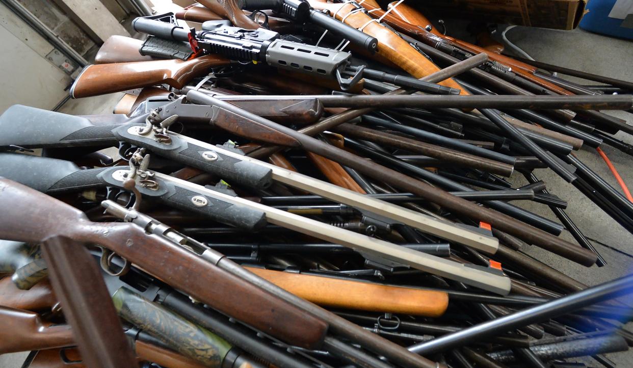 A stack of long guns, collected during a gun buyback event sponsored by the Erie County District Attorney's office, is displayed at the Erie Bureau of Fire Central Station in Erie on Oct. 28, 2023.