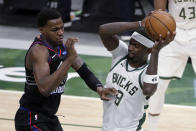 Milwaukee Bucks' Bobby Portis (9) controls a rebound next to Philadelphia 76ers' Paul Reed during the second half of an NBA basketball game Thursday, April 22, 2021, in Milwaukee. (AP Photo/Aaron Gash)