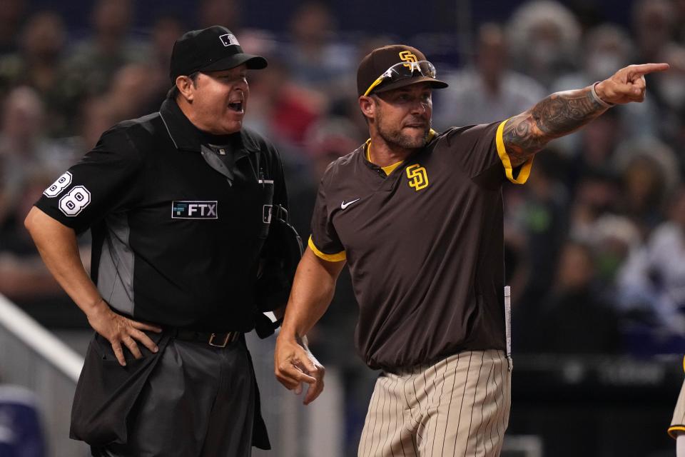 Skip Schumaker, then an associate manager with the Padres, argues a call made after being ejected by home plate umpire Doug Eddings while playing the Marlins in Miami in 2021.