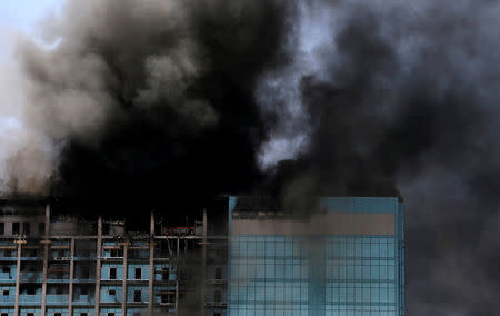 Smoke rises after a fire broke out in a building in Abu Dhabi, UAE, August 30, 2016. REUTERS/Stringer