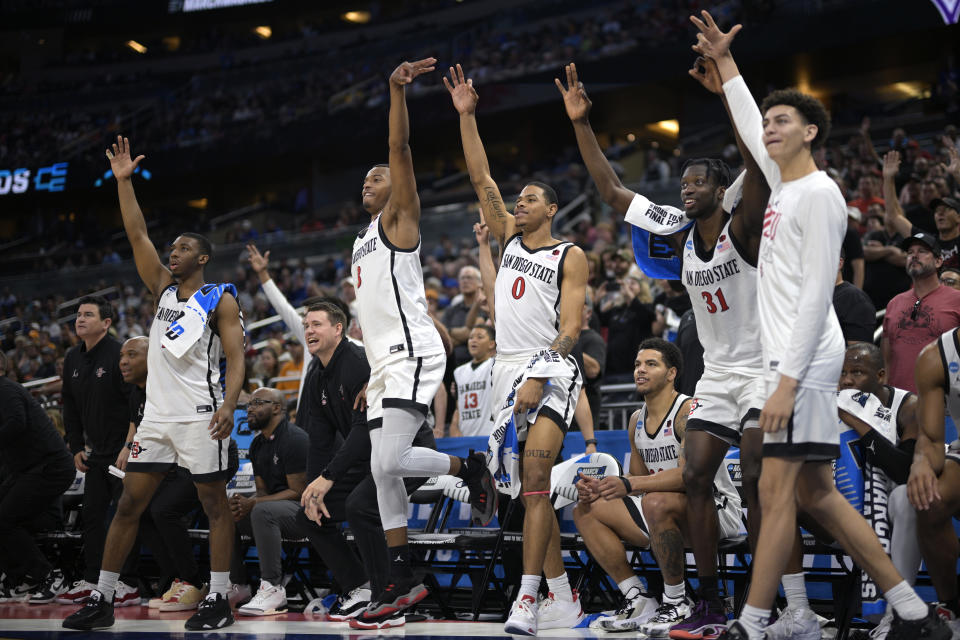 San Diego State players celebrate a teammate's 3-pointer late in the second half of a second-round college basketball game against Furman in the NCAA Tournament, Saturday, March 18, 2023, in Orlando, Fla. (AP Photo/Phelan M. Ebenhack)