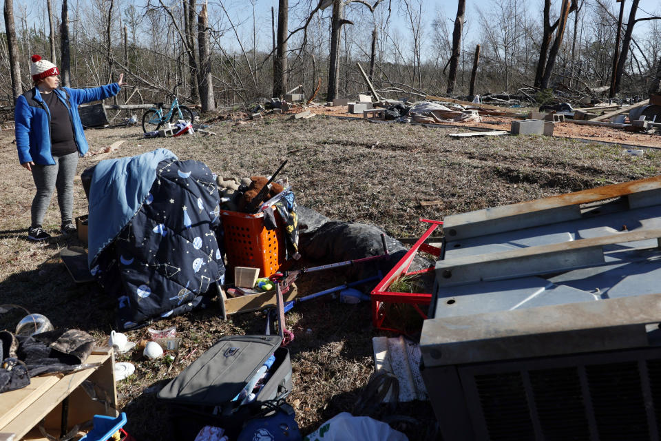 Leighea Johnson points to where her mobile home was located before a tornado that ripped through Central Alabama earlier this week destroying her home on Saturday, Jan. 14, 2023 in Marbury, Ala. Her daughter and grandson where in the home and survived with minor injuries. (AP Photo/Butch Dill)