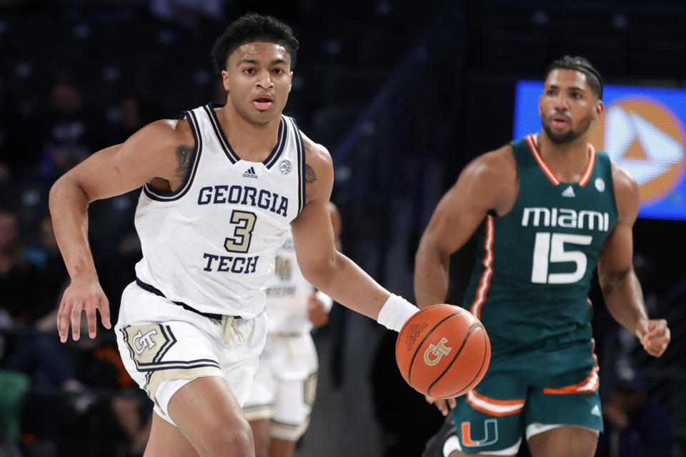 Georgia Tech guard Dallan Coleman, left, brings the ball up, followed by Miami forward Norchad Omier during the first half of an NCAA college basketball game Wednesday, Jan. 4, 2023, in Atlanta. (AP Photo/Alex Slitz)