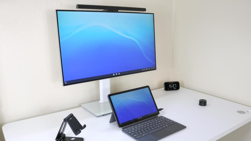 A side view of a desk setup with a monitor light bar on top of the monitor