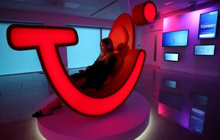 A woman demonstrates a prototype of a new TUI holiday-selection service as the company announced the rebranding of its UK operation, in London, Britain, October 17, 2017. Picture taken on October 17, 2017. REUTERS/Hannah McKay