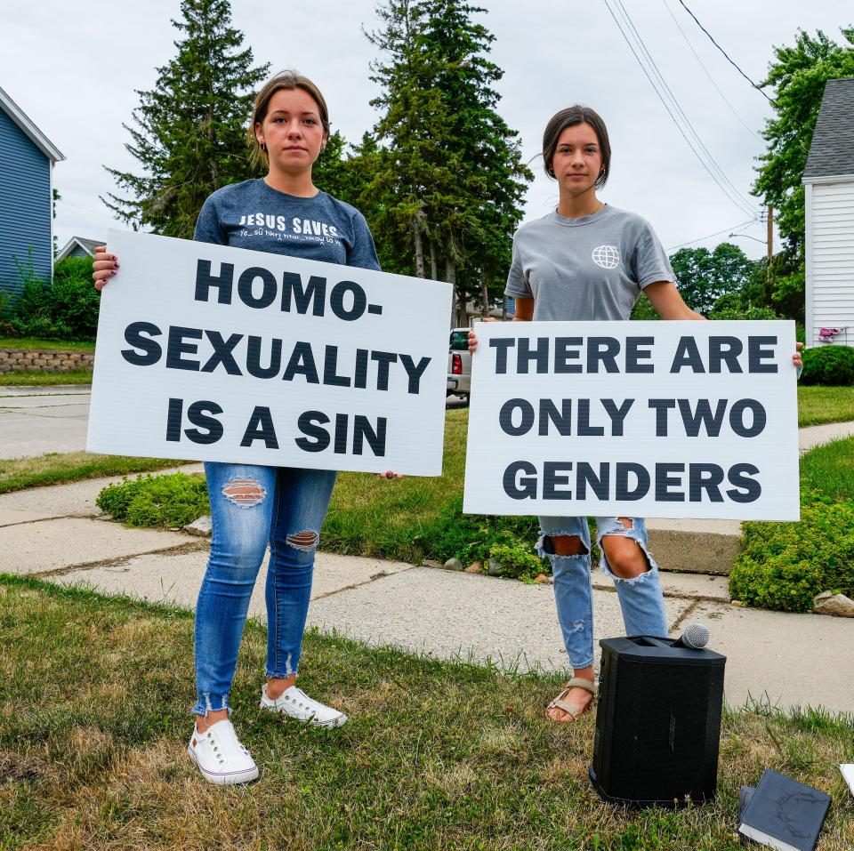 Director of Operation Save America Jason Storms' daughters, Ali Storms, left, and her sister Julia, both of Grafton, came to the Waukesha School Board's July 12 meeting to support the board members and their decision to ban the song "Rainbowland" from a spring concert at Heyer Elementary School. Jason and his children can be seen at various protests speaking out against homosexuality.